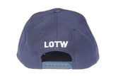 Back view of navy blue LOTW Gear snapback baseball hat with white embroidered logo