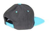 Side view of black and teal LOTW Gear snapback baseball hat with teal logo