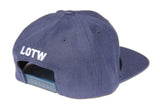 Side view of navy blue LOTW Gear snapback baseball hat with white embroidered logo